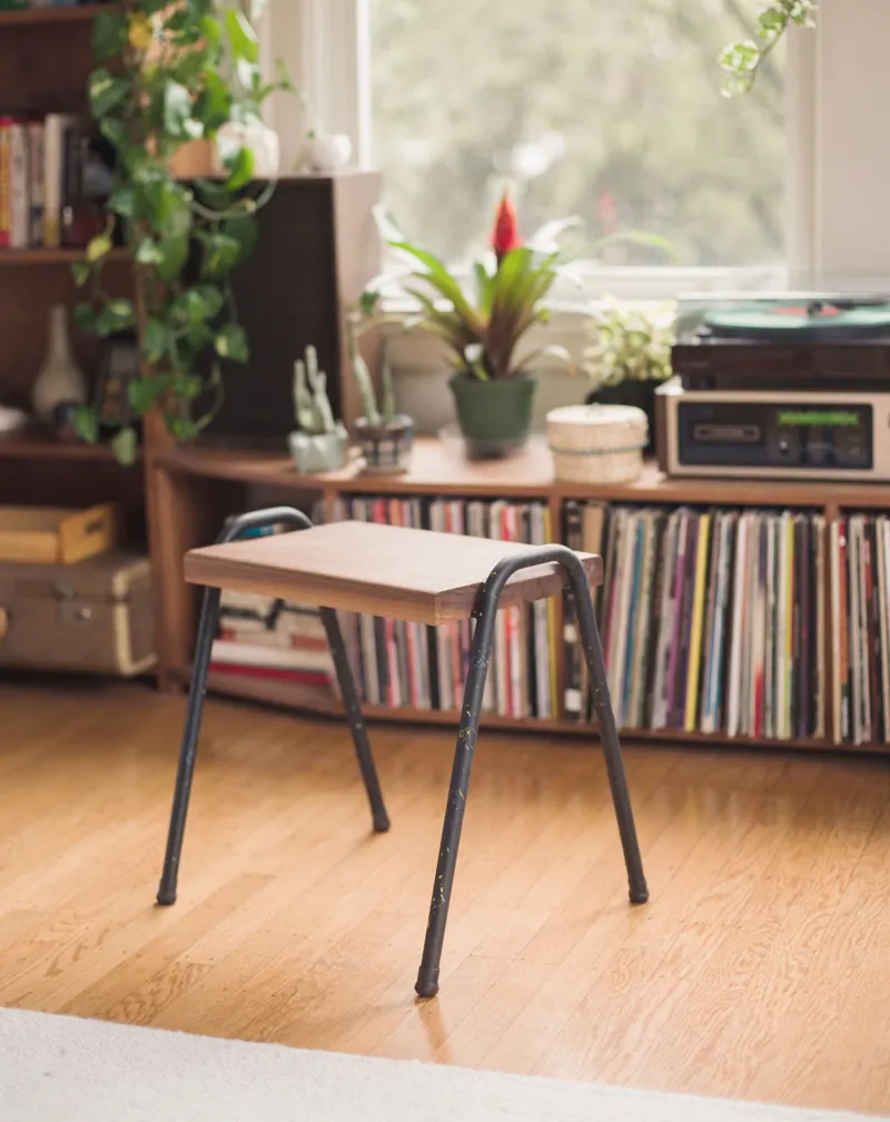 The stool at home, next to a record shelf